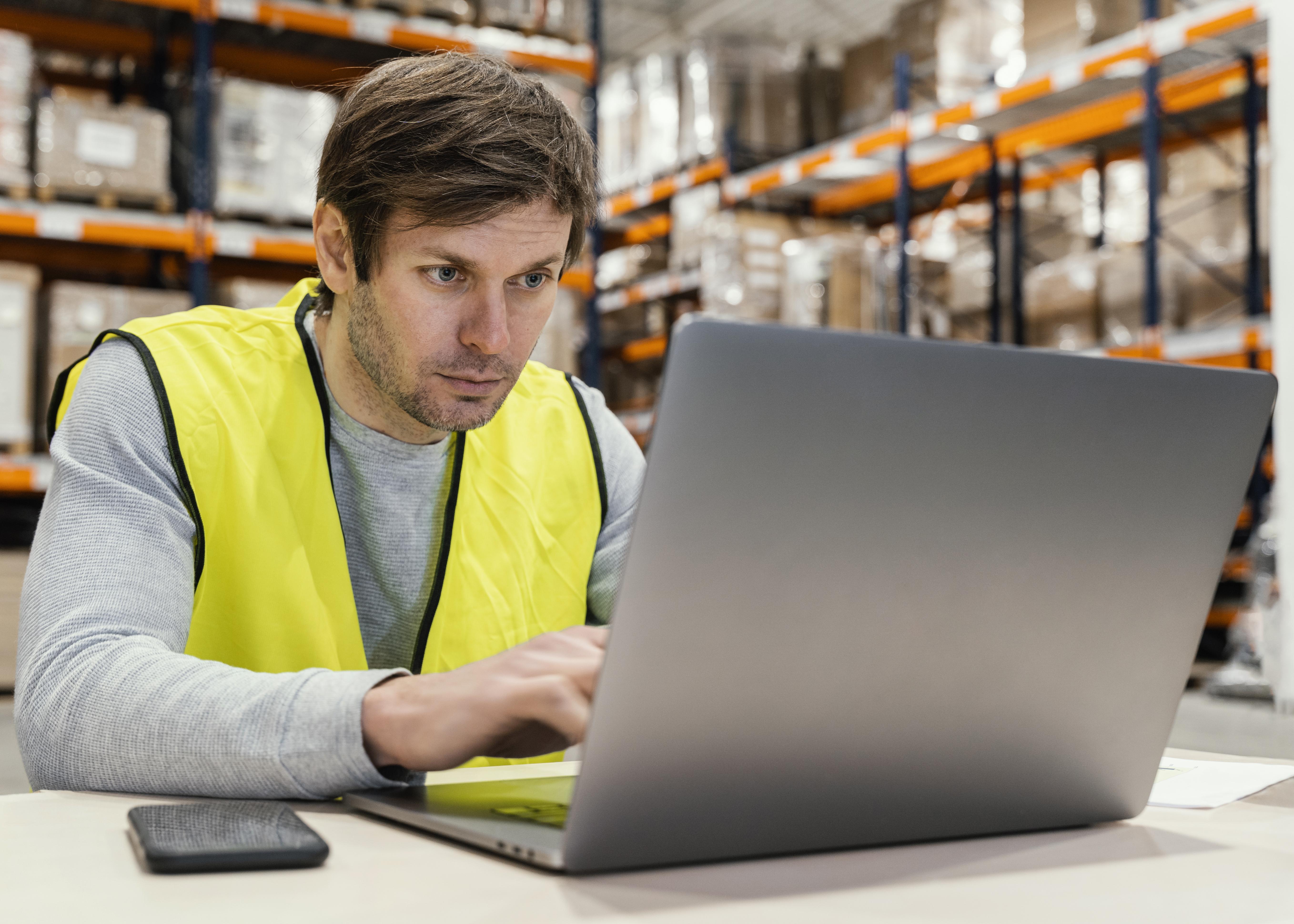man-warehouse-working-laptop